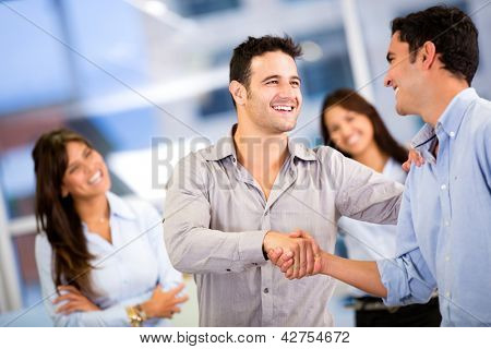 Picture or Photo of Handshake of two business men closing a deal at the office