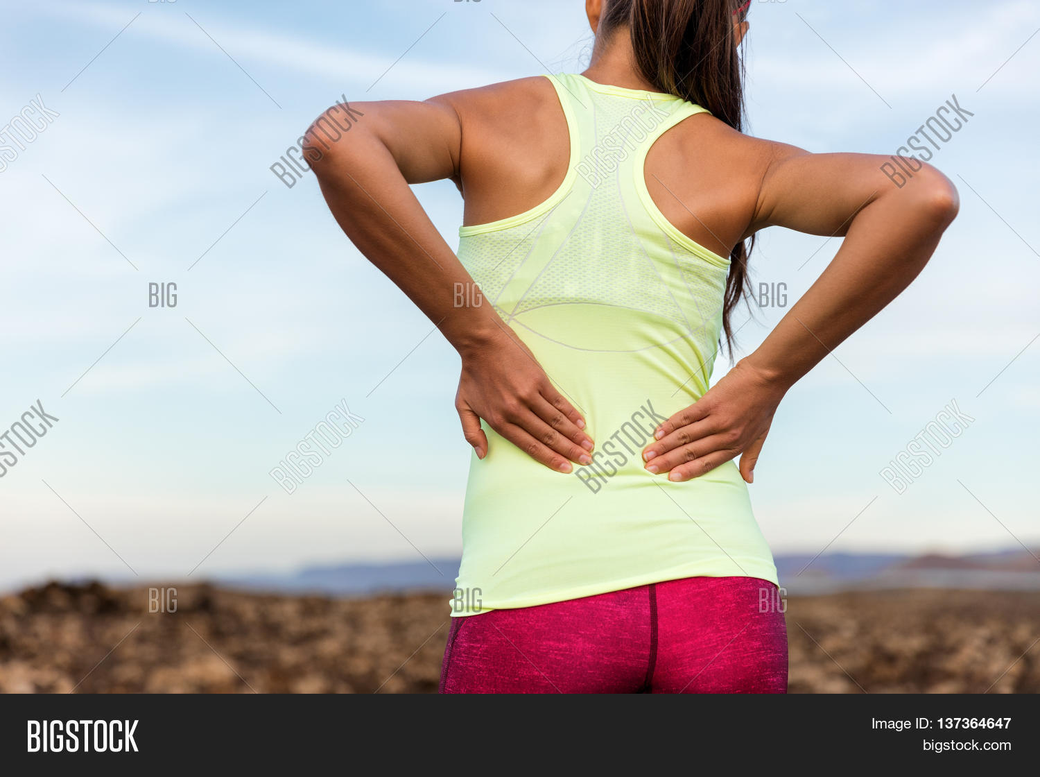 Trail running runner with painful lower back pain injury or strained