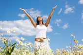 stock photo of blue sky  - Image of happy female standing with raised arms on summer day - JPG 