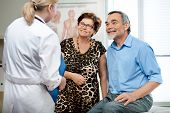 image of medical doctors  - senior couple visiting a doctor at the doctor - JPG 