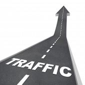 stock photo of web  - The word Traffic on a road rising up to represent increased activity on the web or transportation system such as freeways and highways - JPG 