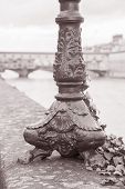 picture of bridge  - Lamppost Base and the Ponte Vecchio Bridge with River Arno Florence Italy in Black and White Sepia Tone - JPG 
