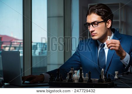 Poster: Businessman playing chess in strategy