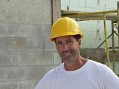stock photo of construction worker  - close shot of construction worker at site in hard hat - JPG 