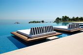 stock photo of beach  - Infinity swimming pool by beach at the modern luxury hotel Pieria Greece - JPG 