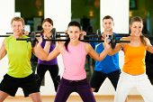 stock photo of health  - Group of five people exercising using barbells in gym or fitness club to gain strength and fitness - JPG 
