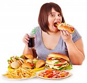 stock photo of food  - Overweight woman eating fast food - JPG 