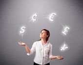 picture of currency  - pretty young lady standing and juggling with currency icons - JPG 