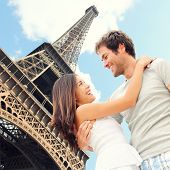 stock photo of france  - Paris Eiffel tower romantic couple embracing kissing in front of Eiffel Tower Paris France - JPG 