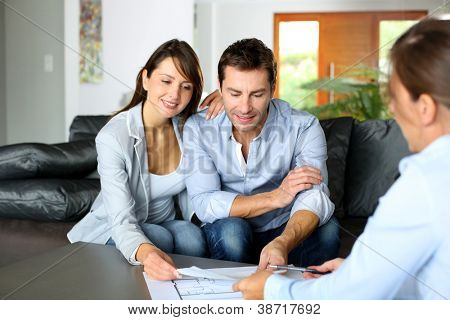 Picture or Photo of Couple meeting consultant for financial contract