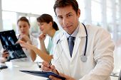 image of medical doctors  - Portrait of doctor sitting in office - JPG 