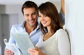 image of newspaper  - Couple at home reading news on newspaper and internet - JPG 