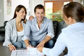 stock photo of future  - Couple signing financial terms for future property - JPG 