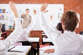 picture of group  - group of students arms up in classroom - JPG 