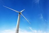 image of generated  - wind turbine generating electricity on blue sky - JPG 