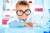 stock photo of science  - Cute boy is making science experiments in a laboratory - JPG 