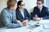 stock photo of meeting  - Image of three business people negotiating at meeting - JPG 