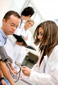 foto of pressure  - doctor and patient during a blood pressure taking procedure - JPG 