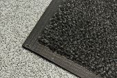stock photo of industrial  - Industrial mats often rented to keep dust levels down in commercial business buildings warehouses or anywhere with polished plastic or sealed floors - JPG 