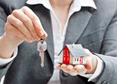 stock photo of agent  - Real estate agent with house model and keys - JPG 