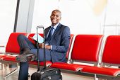 pic of wait  - african american businessman waiting flight in airport - JPG 
