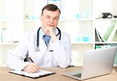 picture of medical doctors  - Medical doctor working at desk - JPG 