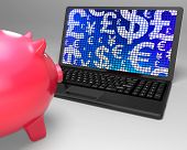 stock photo of currency  - Currencies On Laptop Showing Global Economy Or Forex - JPG 