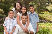 image of family  - Happy Hispanic Family Portrait In the Park - JPG 