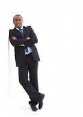 stock photo of man  - Portrait of a happy young African American business man with hands folded on white - JPG 
