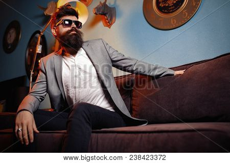 Poster: Brutal Bearded Man Sitting In
