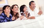 pic of family  - Happy family watching tv together and lying in bed - JPG 