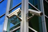 pic of security  - two city security cameras on the glass facade - JPG 