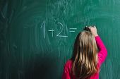 pic of watch  - happy school girl on math classes finding solution and solving problems - JPG 