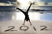 stock photo of beach  - happy new year 2012 on the beach with sunrise - JPG 