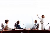 image of businesspeople  - Image of businesspeople at presentation looking at screen - JPG 