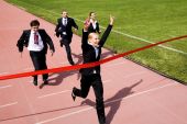 pic of business people  - Photo of happy businesswoman crossing finish line during race - JPG 
