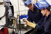 stock photo of people welding - Engineer Teaching Apprentice To Use TIG Welding Machine - JPG