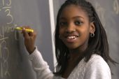 stock photo of student  - African American student doing math problems on the chalkboard - JPG 