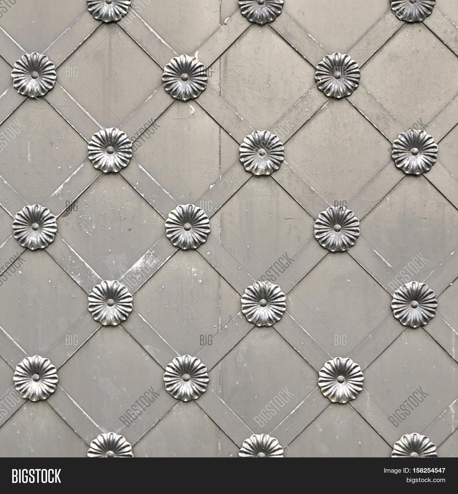old silver metal gate or door with iron forged decorative grid old silver metal gate or door with iron forged decorative grid