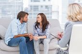 foto of watch  - Couple looking to each other during therapy session while therapist watches - JPG 