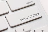 pic of investment  - save money for investment concept with a blue button on computer keyboard - JPG 