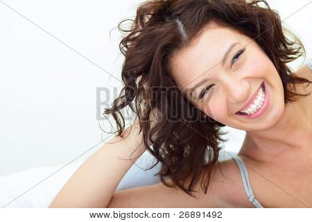 Picture or Photo of Beautiful woman lying on the sofa and laughing sincerely