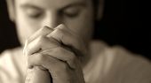 image of religion  - A man is holding his hands in prayer.
** Note: Shallow depth of field - JPG 
