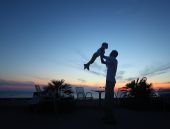 image of blue sky  - Silhouette of man with child in hands on sunset - JPG 