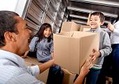 pic of truck  - Family moving house loading a truck with boxes - JPG 