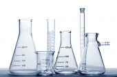 picture of science  - Assorted labware with glass Erlenmeyer flasks beaker and cylinders for an experiment in a science research lab - JPG 