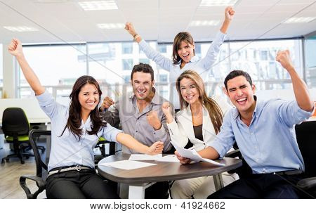 Picture or Photo of Successful business team with arms up at the office