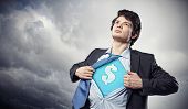 stock photo of leadership  - Image of young businessman in superhero suit with dollar sign on chest - JPG 