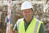 picture of construction worker  - Construction Worker Holding Measure - JPG 