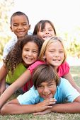 stock photo of children  - Group Of Children Piled Up In Park - JPG 